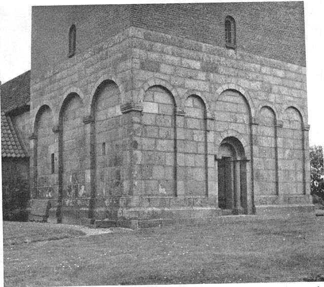 (Foto). Underdelen af tårnet på Bejstrup kirke. Opført af granitkvadre og prydet med romanske arkadeblændinger.