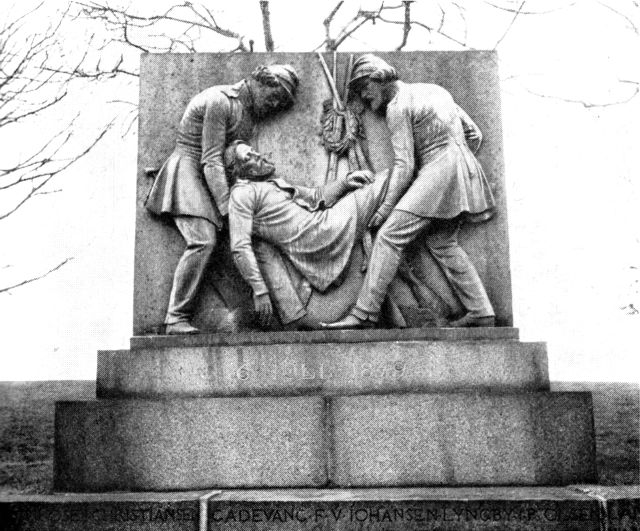 (Foto). Monument over de faldne 1849 med bronzerelief forestillende »Soldater som begraver deres faldne kammerat«. Udført af H. V. Bissen 1851.